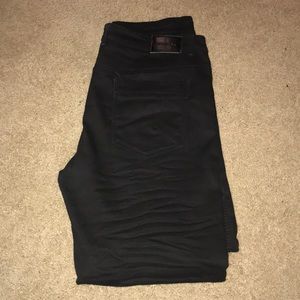 Jet black, distressed, straight leg jeans.